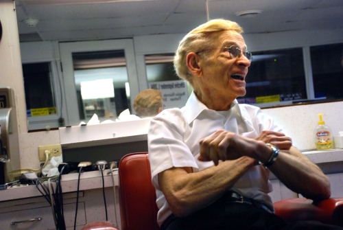 Charlie Fletemake, 87, owner of Charlie's Barber Shop in Bellefonte, Pennsylvania sits in his shop on Tuesday