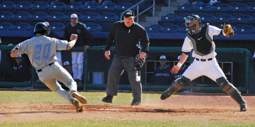 NYIT catcher, George Carroll, slides into home plate as Penn State's Bobby Jacobs attempts to make the tag, during a March 20th game at Medlar Field in University Park, Pennsylvania. The Nittany Lions went on to win the game 4-2