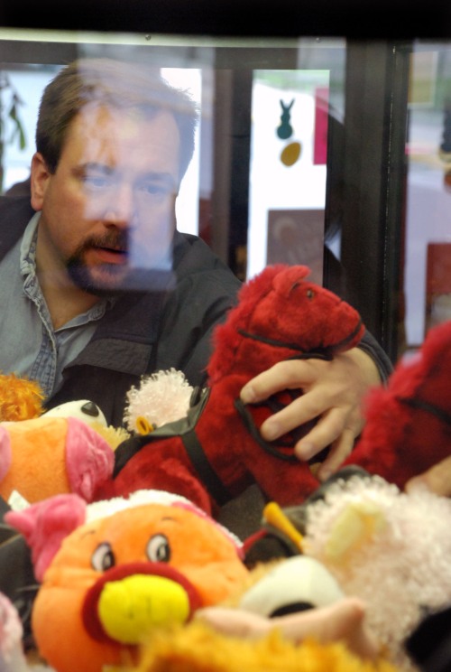 Troy Homan, an employee of State Amusement refills a crane game in a Dairy Queen in Bellefonte Pennsylvania.
